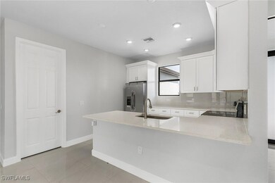 Kitchen featuring stainless steel refrigerator wit