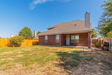 The spacious back yard has a covered patio and roo