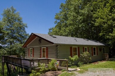 Log sided mountain retreat tucked in the woods at