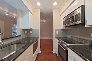 The spacious kitchen offers granite counters, pret
