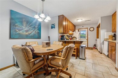 807 Charleston -Dining space featuring a chandelier, light tile patterned flooring, and baseboards