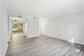 Unfurnished living room with wood finished floors and baseboards