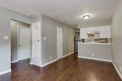 Kitchen with freestanding refrigerator, dark wood