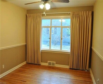 Dining room offers wood floors & chair rail, pictu