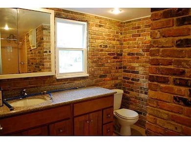 Bath. Unique bathroom-exposed brick, granite countger tops.