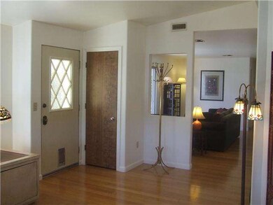 Front door entryway with storage closet. Bamboo fl