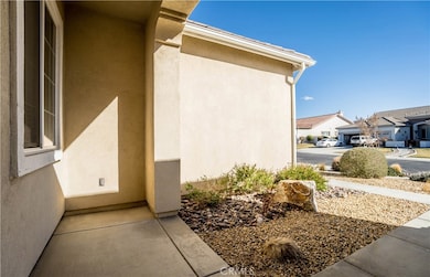 Covered entryway, stucco exterior, rain gutters