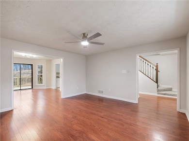 Spare room featuring ceiling fan, dark hardwood / 
