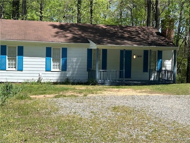 Ranch-style house with covered porch, a chimney, a