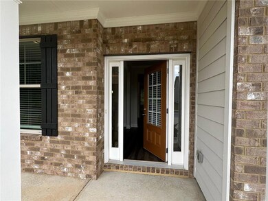 Property entrance featuring brick siding