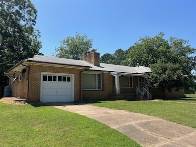Ranch-style house featuring a garage and a front l