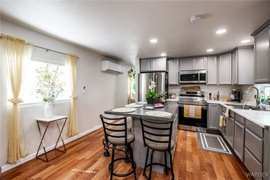 Kitchen with light wood-type flooring, stainless s