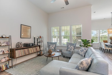 Living room with light hardwood / wood-style floor