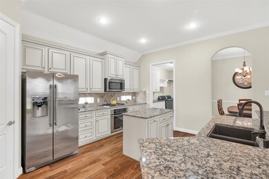 The spacious utility room (pictured at right) feat