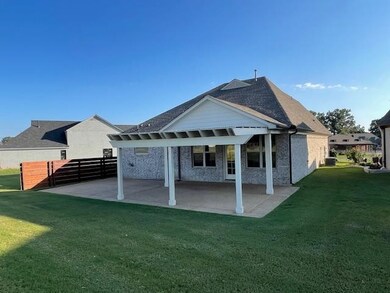 Rear view of property with a yard and a patio area