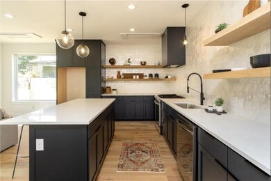 Kitchen featuring tasteful backsplash, open shelv