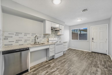 Kitchen with visible vents, dishwasher, under cab
