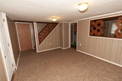 Living room. Newer carpet and interior paneling.