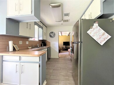 Kitchen with stainless steel appliances, tile flooring and lots of cabinet space