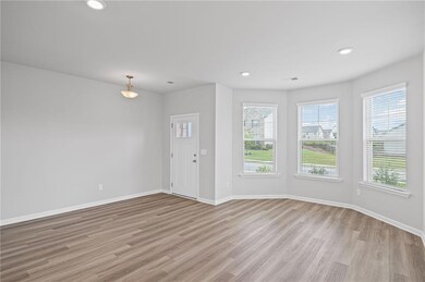 Entrance foyer featuring plenty of natural light, light wood-style floors, baseboards, and recessed lighting