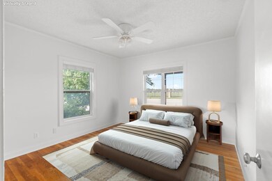 Bedroom featuring multiple windows, crown molding