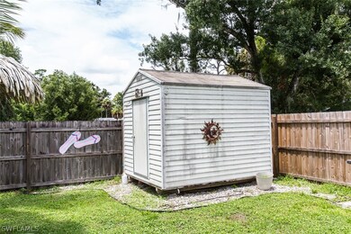 View of outbuilding with a yard
