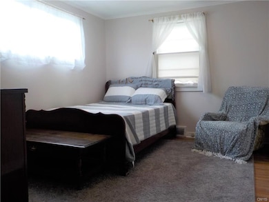 First floor bedroom with hardwood floors.