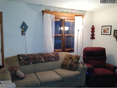 The living room is open to the dining area and is 