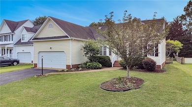View of front of home featuring driveway, roof wit
