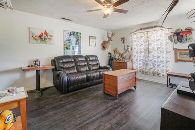 Living room with dark wood-type flooring, ceiling 