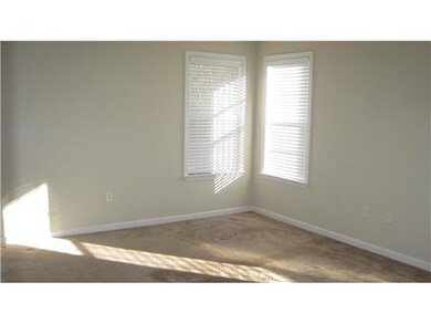 This master bedroom has 3 windows that let natural sunlight flood the room.