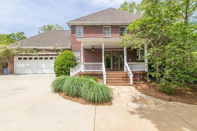 VIEW OF SIDE PORCH AND GARAGE FROM DRIVEWAY