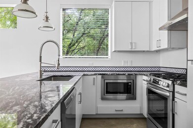 Kitchen with stainless steel appliances, wall chi