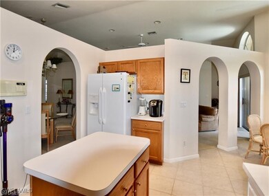 Kitchen with a kitchen island, white refrigerator