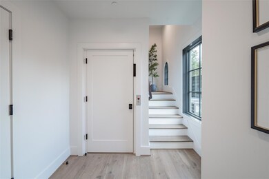 Foyer entrance with light hardwood / wood-style fl