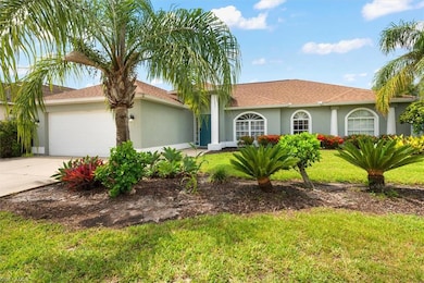 View of front of house with stucco siding, a garage, driveway, and a front lawn