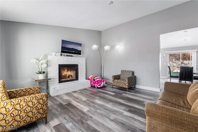 Living area with lofted ceiling, a brick fireplace