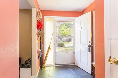 Entryway with slate flooring and screen door.