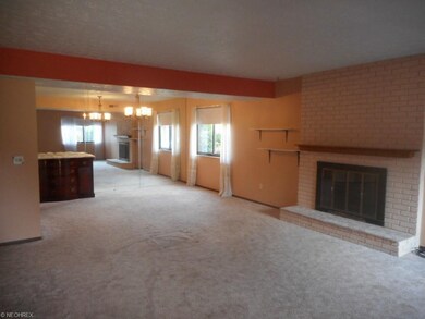 Open family room and dining area with gas fireplac