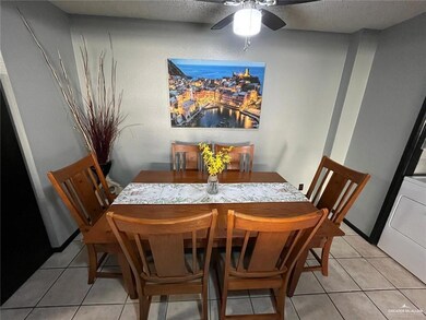 Dining room featuring light tile patterned floors, ceiling fan, a textured ceiling, and washer / clothes dryer