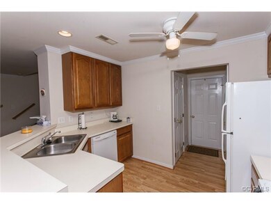 Galley kitchen opens to living area.