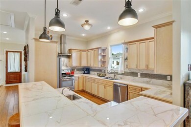 Large kitchen with bar top, prep sink, dishwasher,