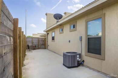 View of property exterior featuring central air condition unit, a patio area, fence, and stucco siding