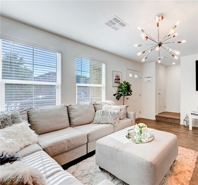 Living room featuring a chandelier, wood finished