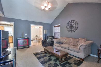 Vaulted Ceilings in your living room which leads to your kitchen and dining room.