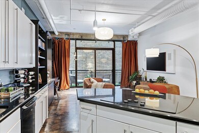 Kitchen featuring black appliances, finished conc