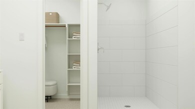 Full bath featuring a spacious closet, a shower st