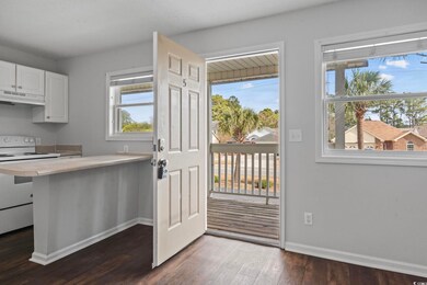 Doorway to outside with baseboards and wood finished floors
