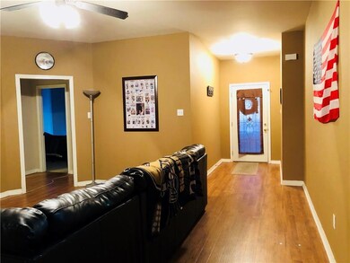 Foyer leading to living room with open floor plan.