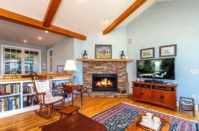 Great room with beamed vaulted ceiling and Hickory